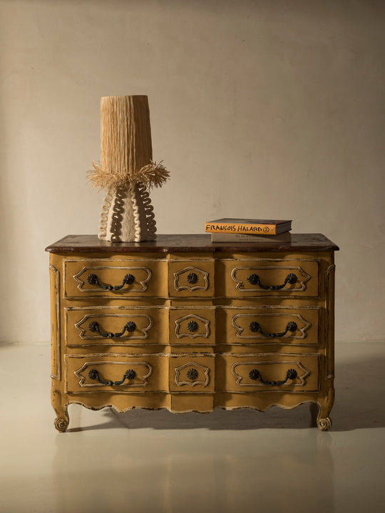 Chest of drawers from the 1920s with yellow and marbled patina