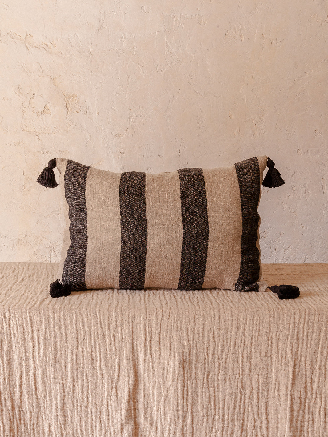 Striped linen cushion with tassels