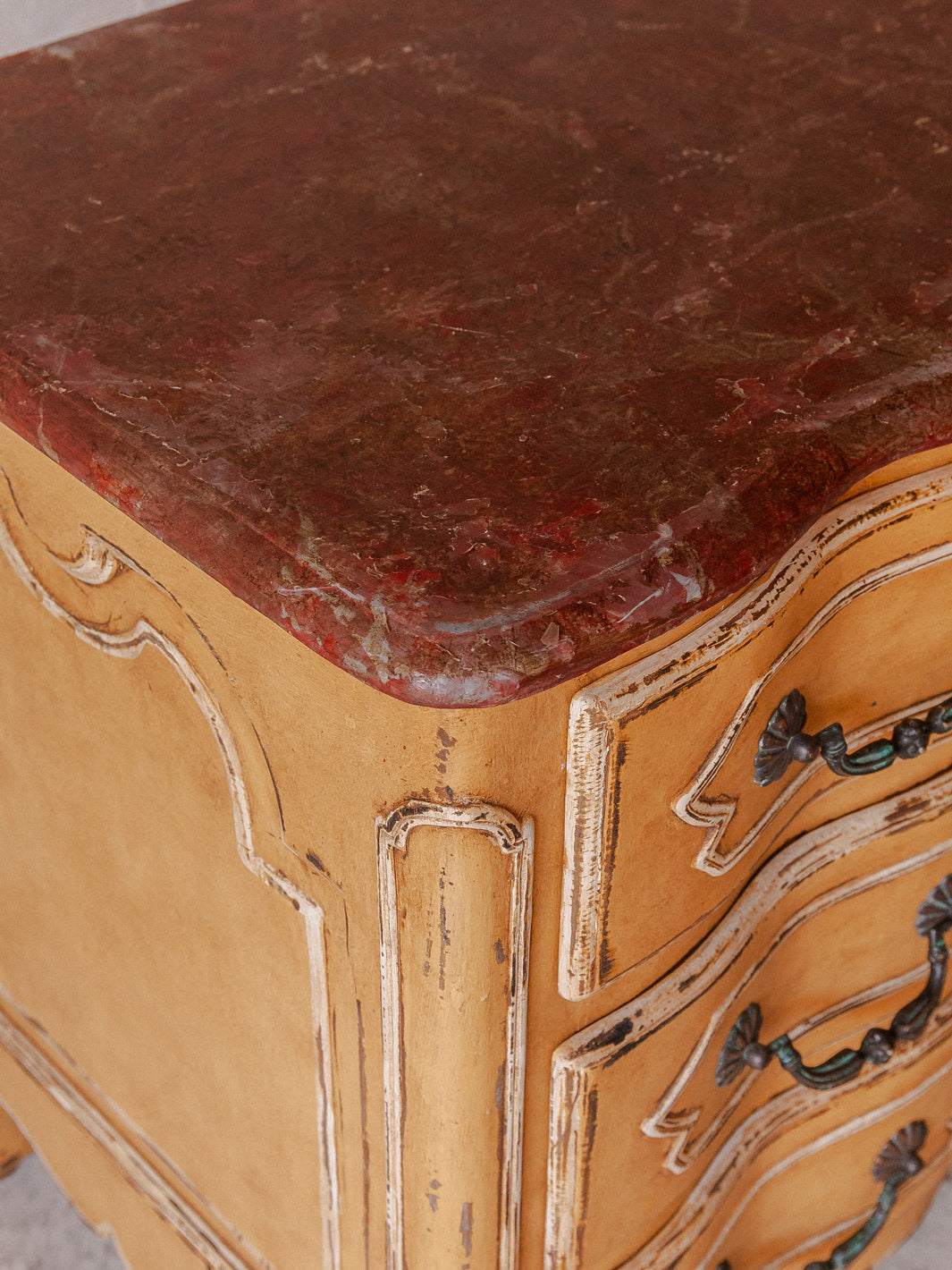 Chest of drawers from the 1920s with yellow and marbled patina