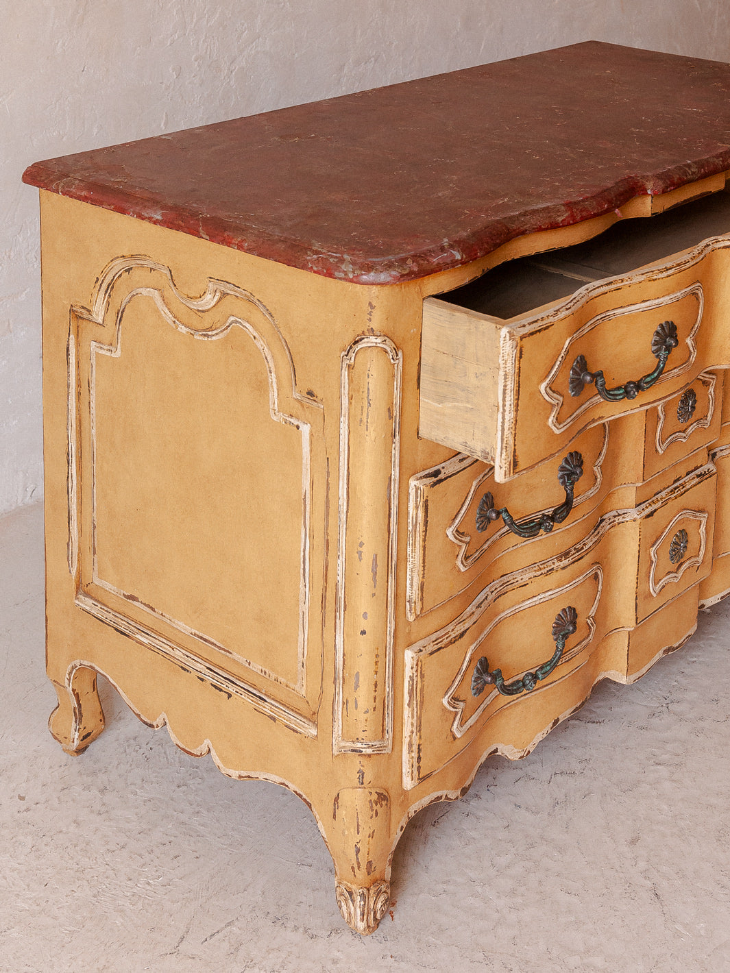 Chest of drawers from the 20s with yellow and marbled patina