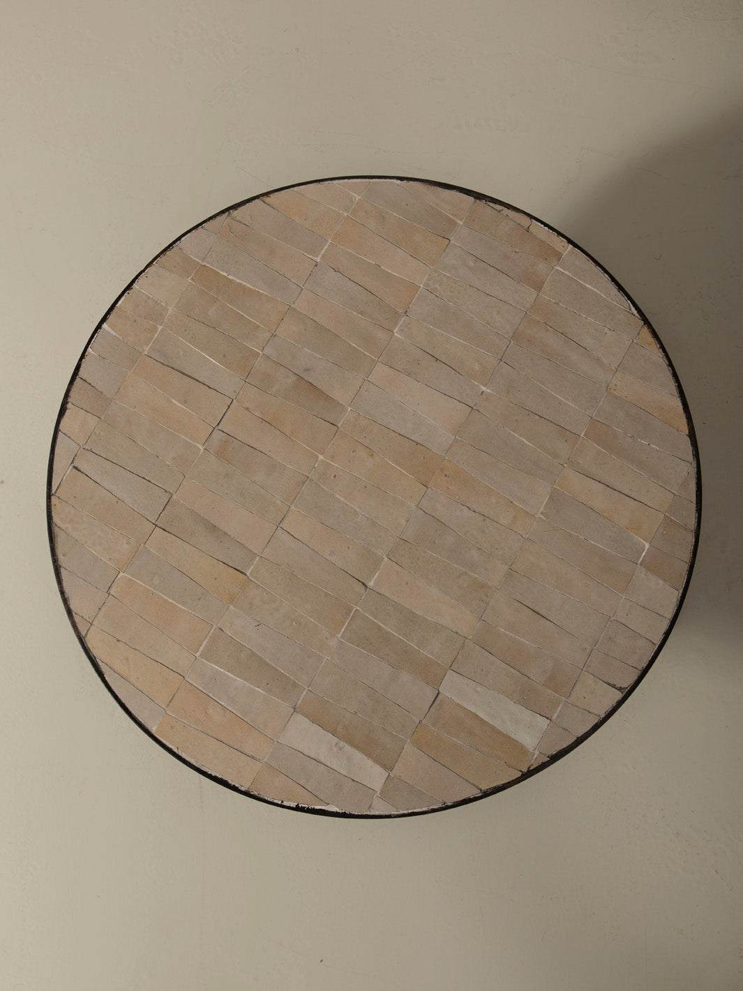 Zellige and iron beige round coffee table
