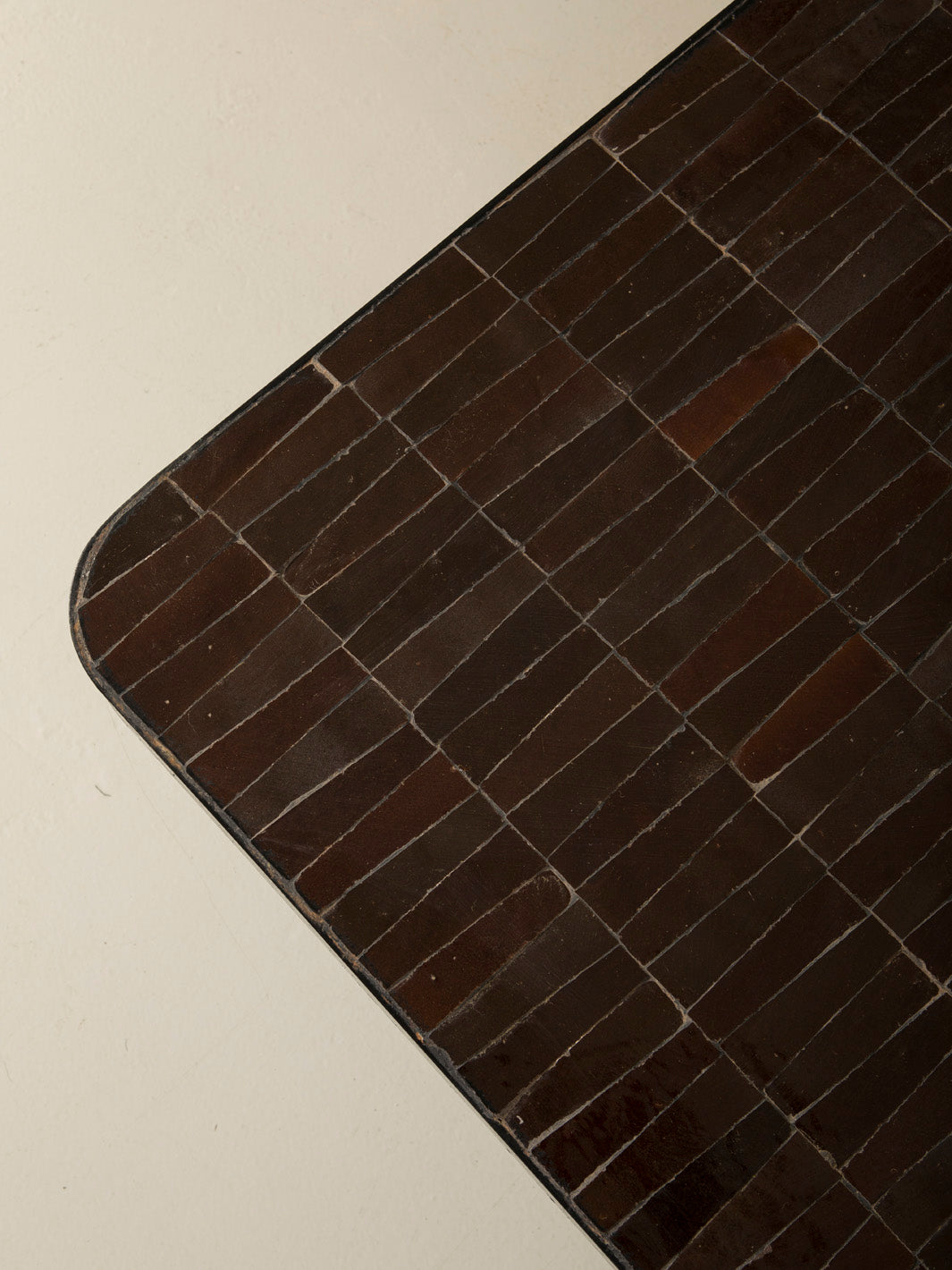 Zellige and iron brown curved low table