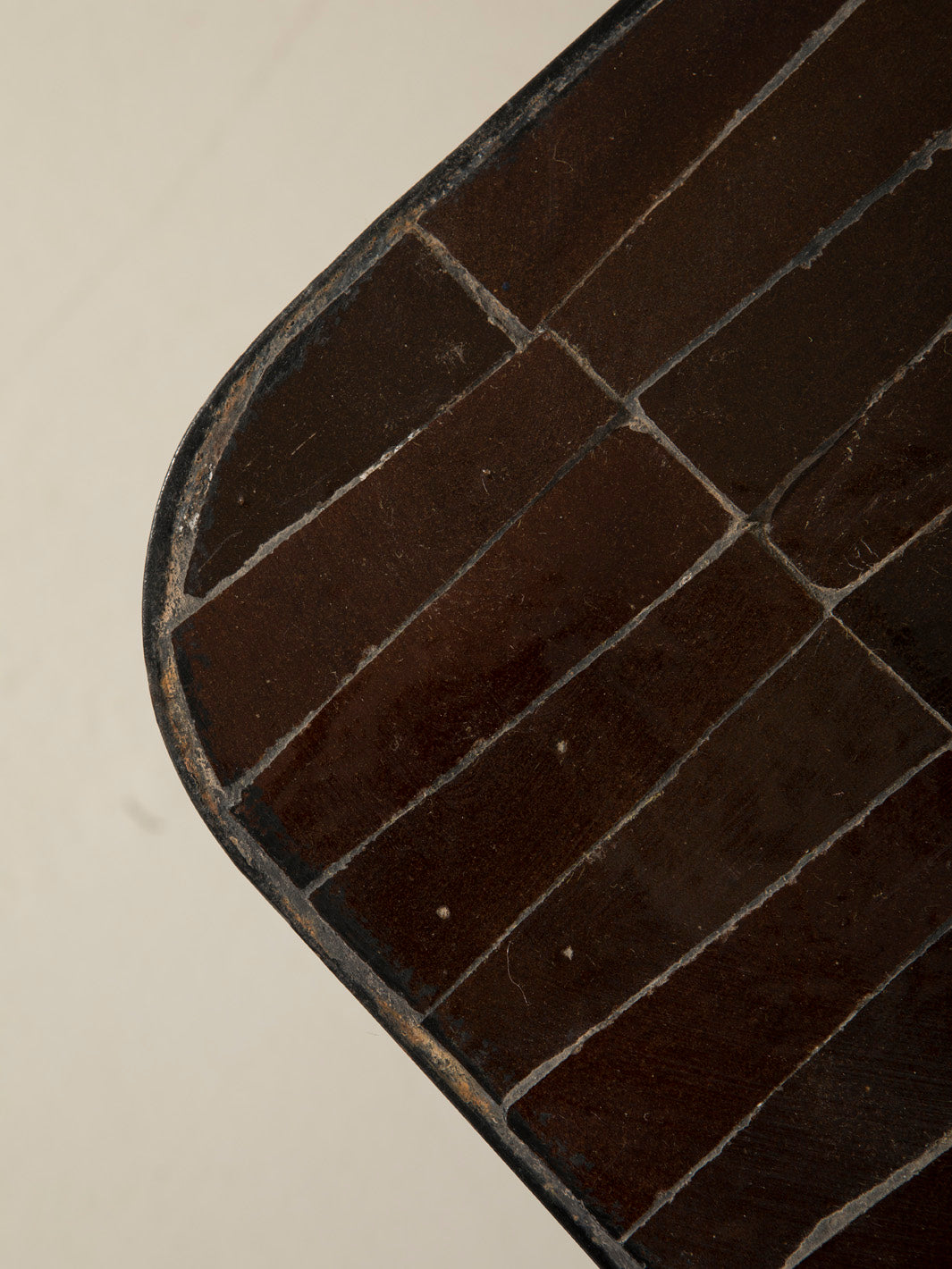 Zellige and iron brown curved low table