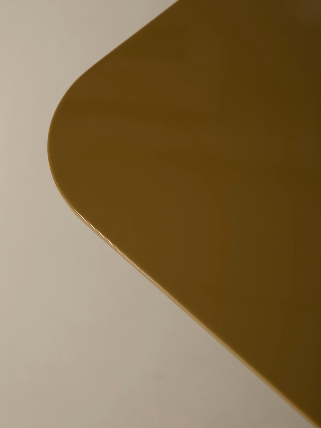 Mesa de comedor lacada en color ámbar con pata cromada