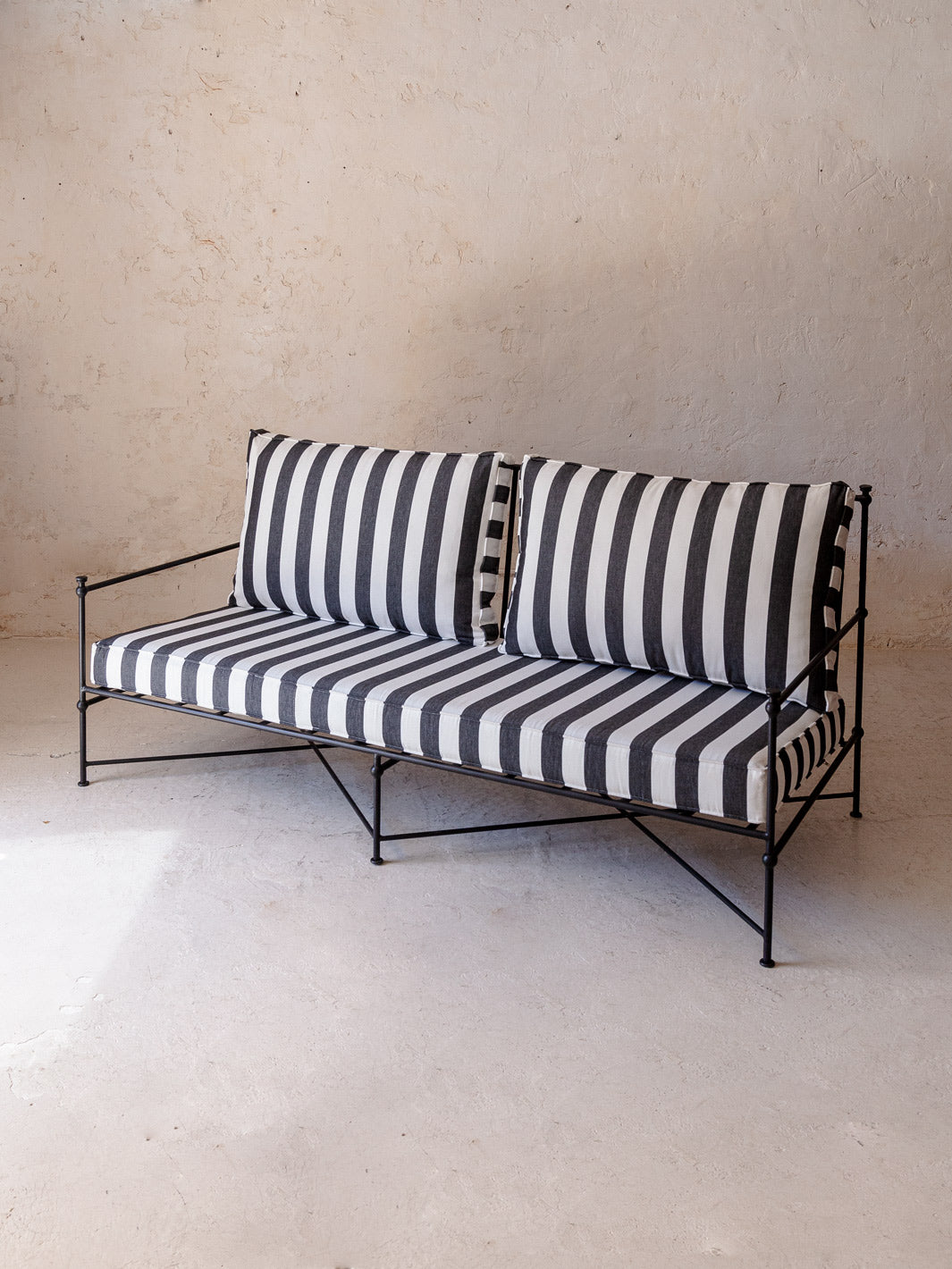 Black and white striped wrought iron sofa