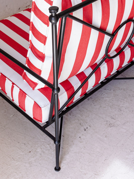 Red and white striped wrought iron sofa
