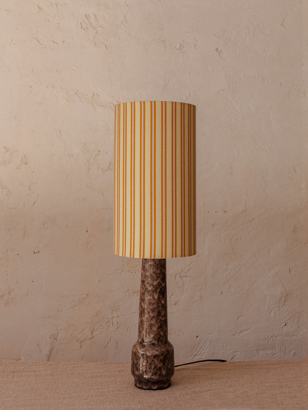 Mauve stoneware lamp with striped shade