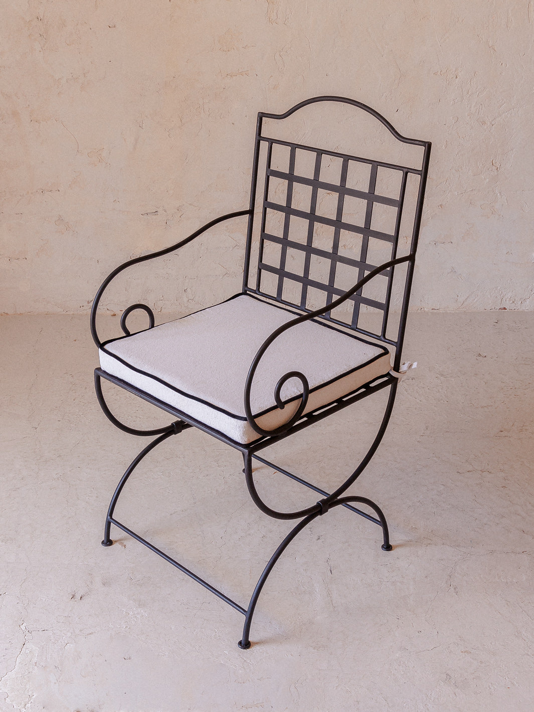 Wrought iron chair with armrests