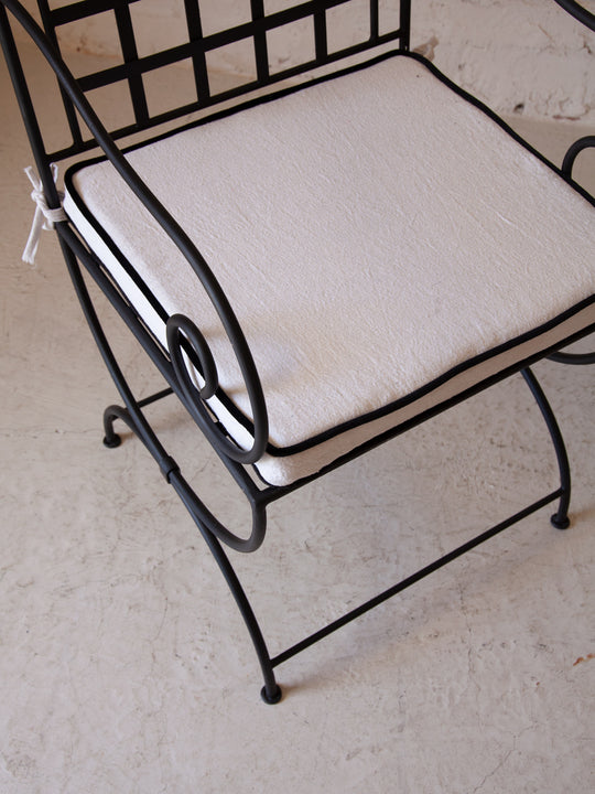 Wrought iron chair with armrests
